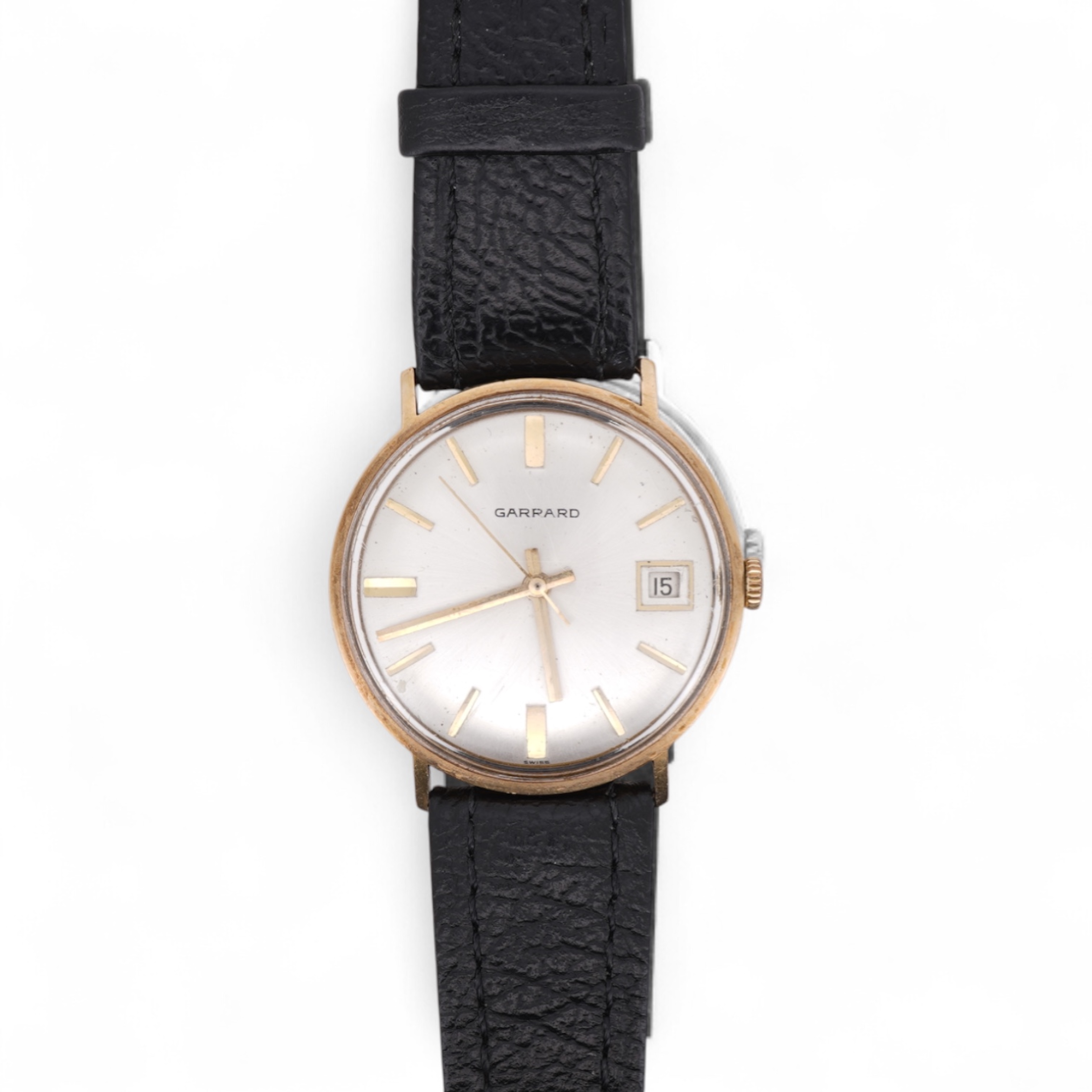 A gentleman's yellow metal Garrard manual wind wrist watch, with baton numerals and date aperture, case diameter 34mm, on a black leather strap.